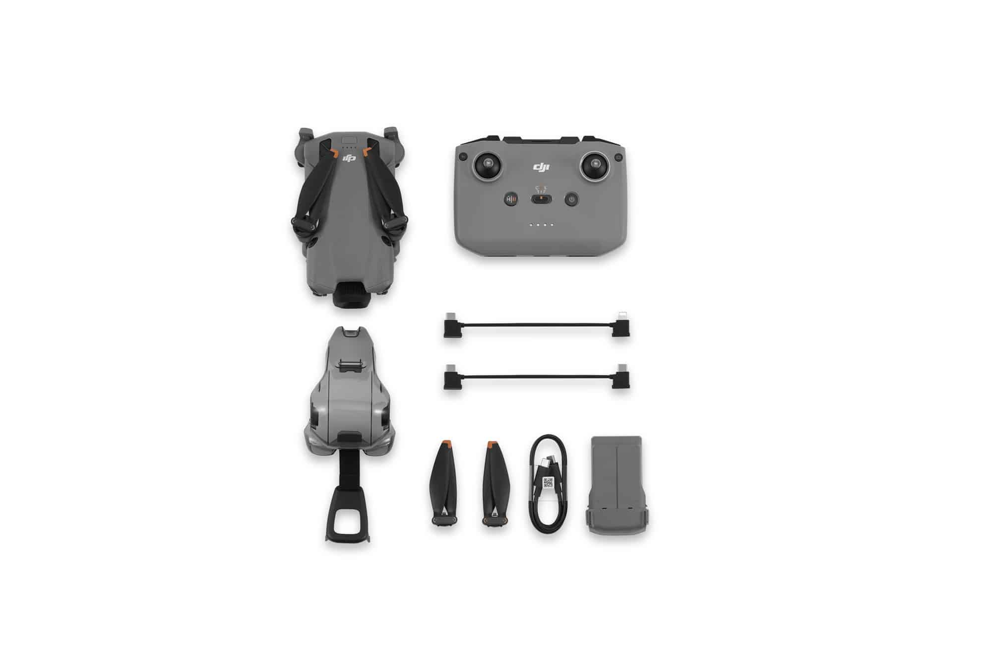 Standard bundle laid flat with the folded drone, plain controller, spare props and battery.
