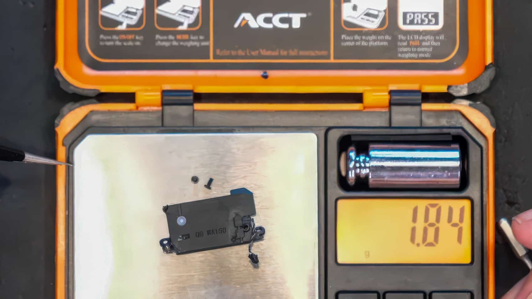 The drone speaker module on a pocket scale reading 1.84 grams.