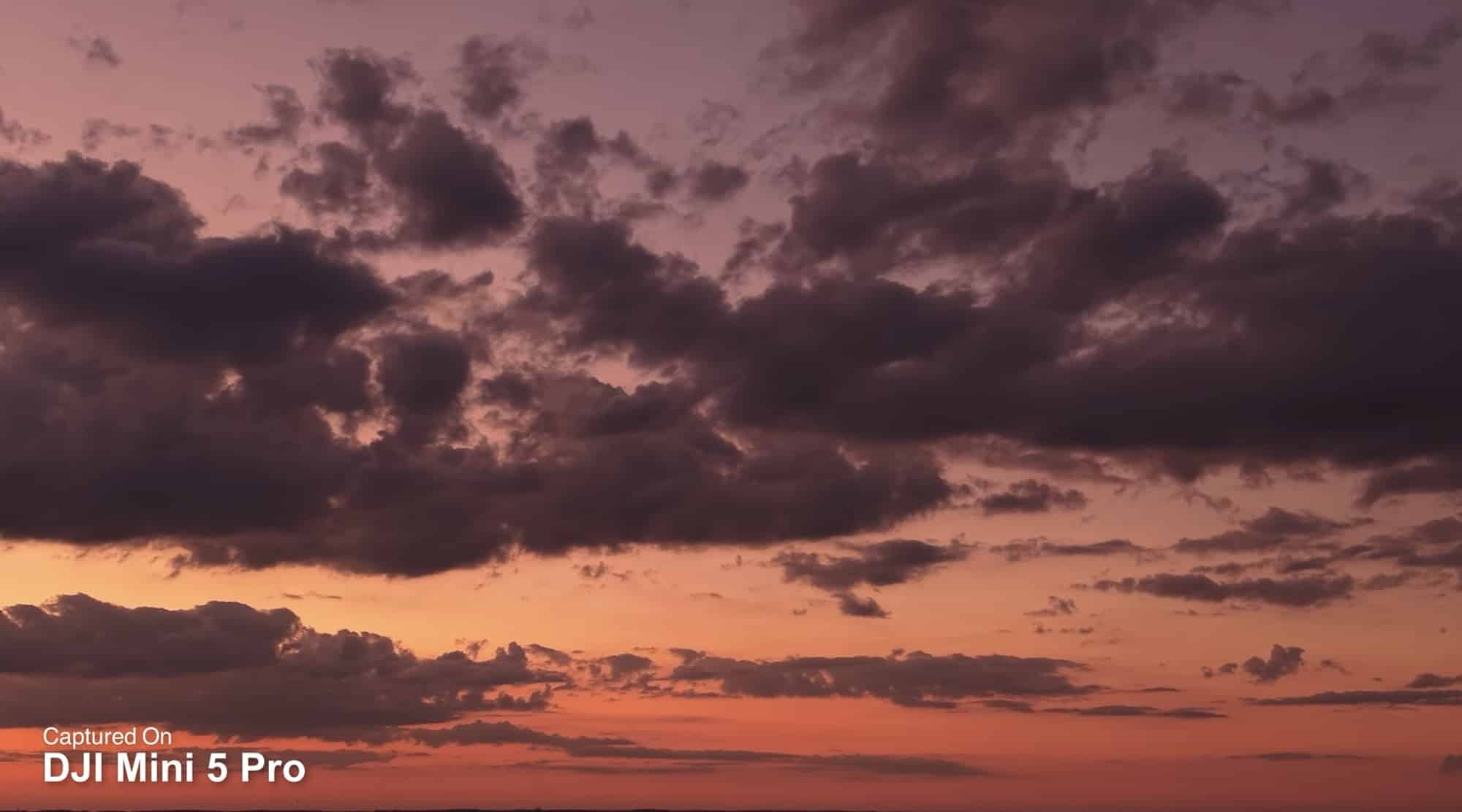 Layered storm clouds over an orange sunset, tagged as captured on the Mini 5 Pro.