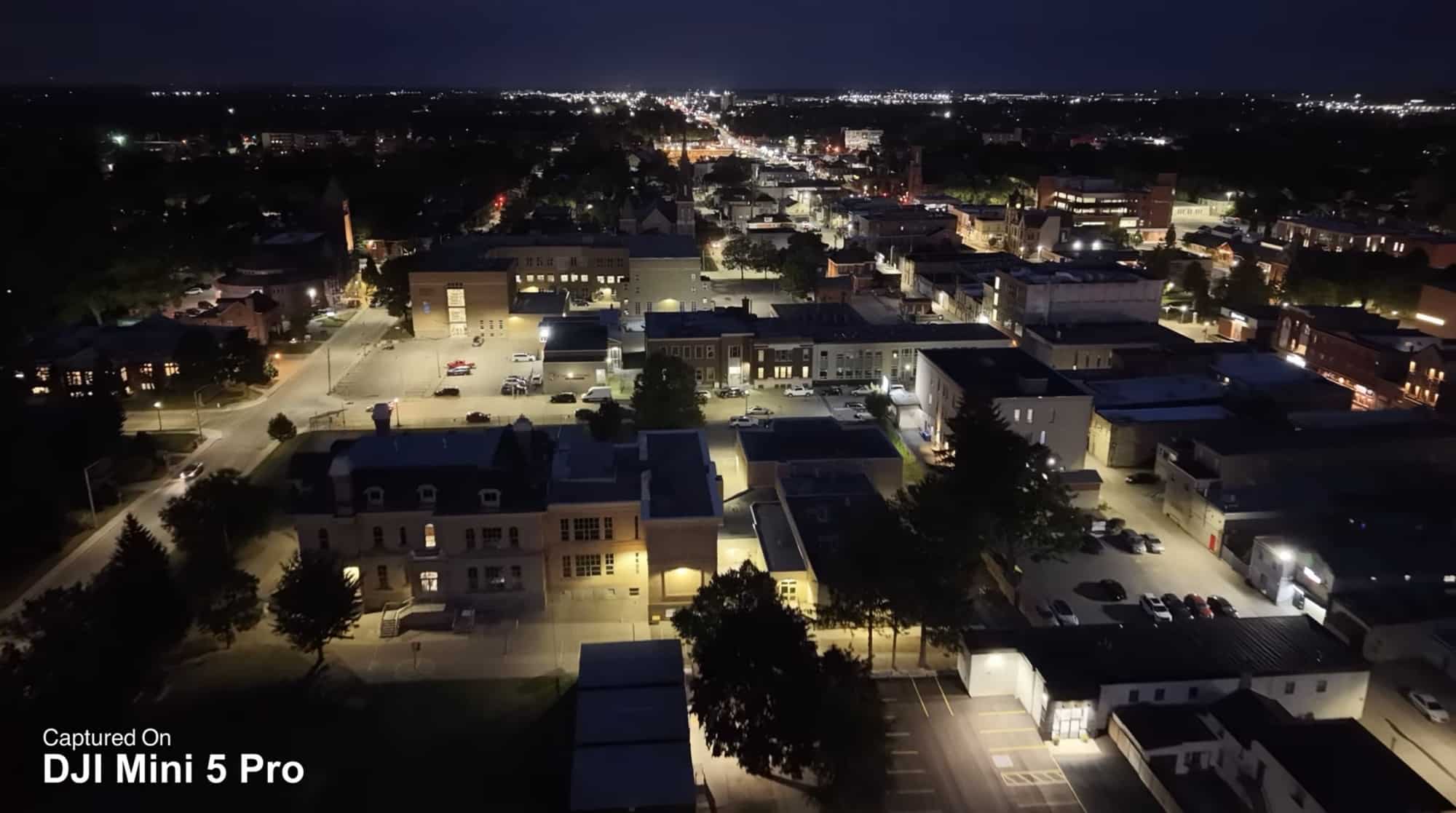 Night aerial over a lit small town, tagged as captured on the Mini 5 Pro.
