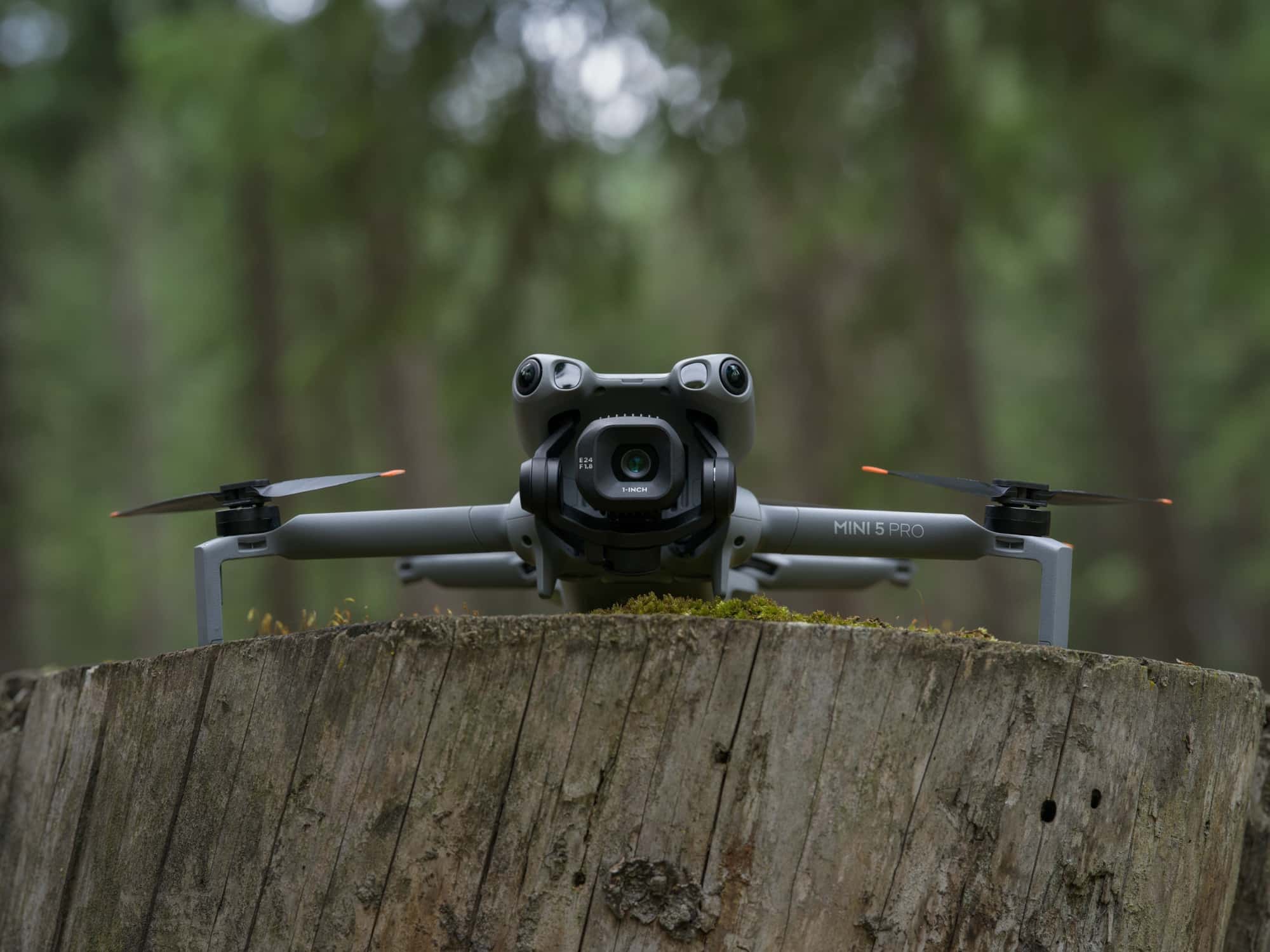 The DJI Mini 5 Pro unfolded, showing its sub-250-gram foldable airframe.
