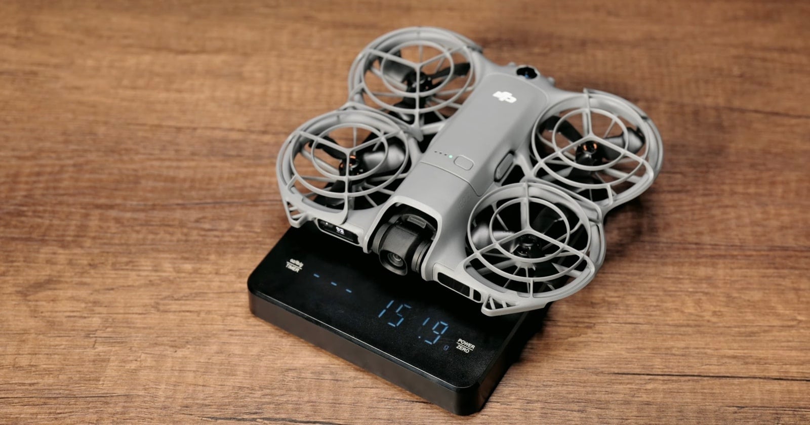 The bare NEO 2 on a kitchen scale reading 151.9 grams.