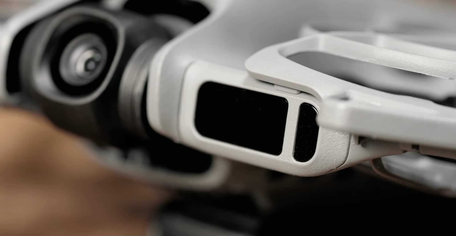Close-up of the front camera housing and the laser sensor window beside it.