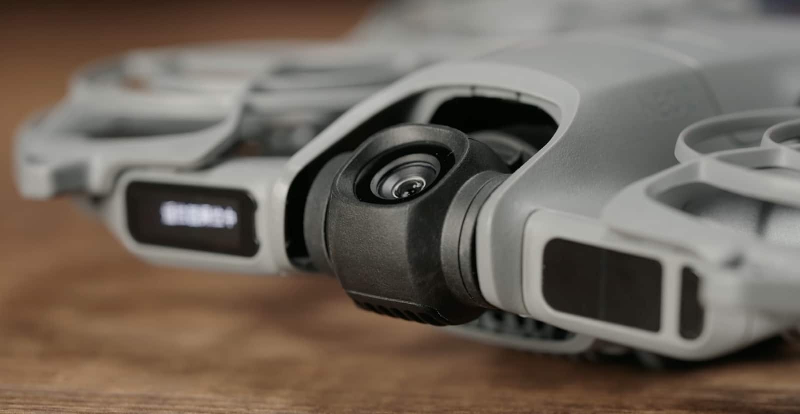 Tabletop close-up of the front info screen and the dual-axis gimbal camera.