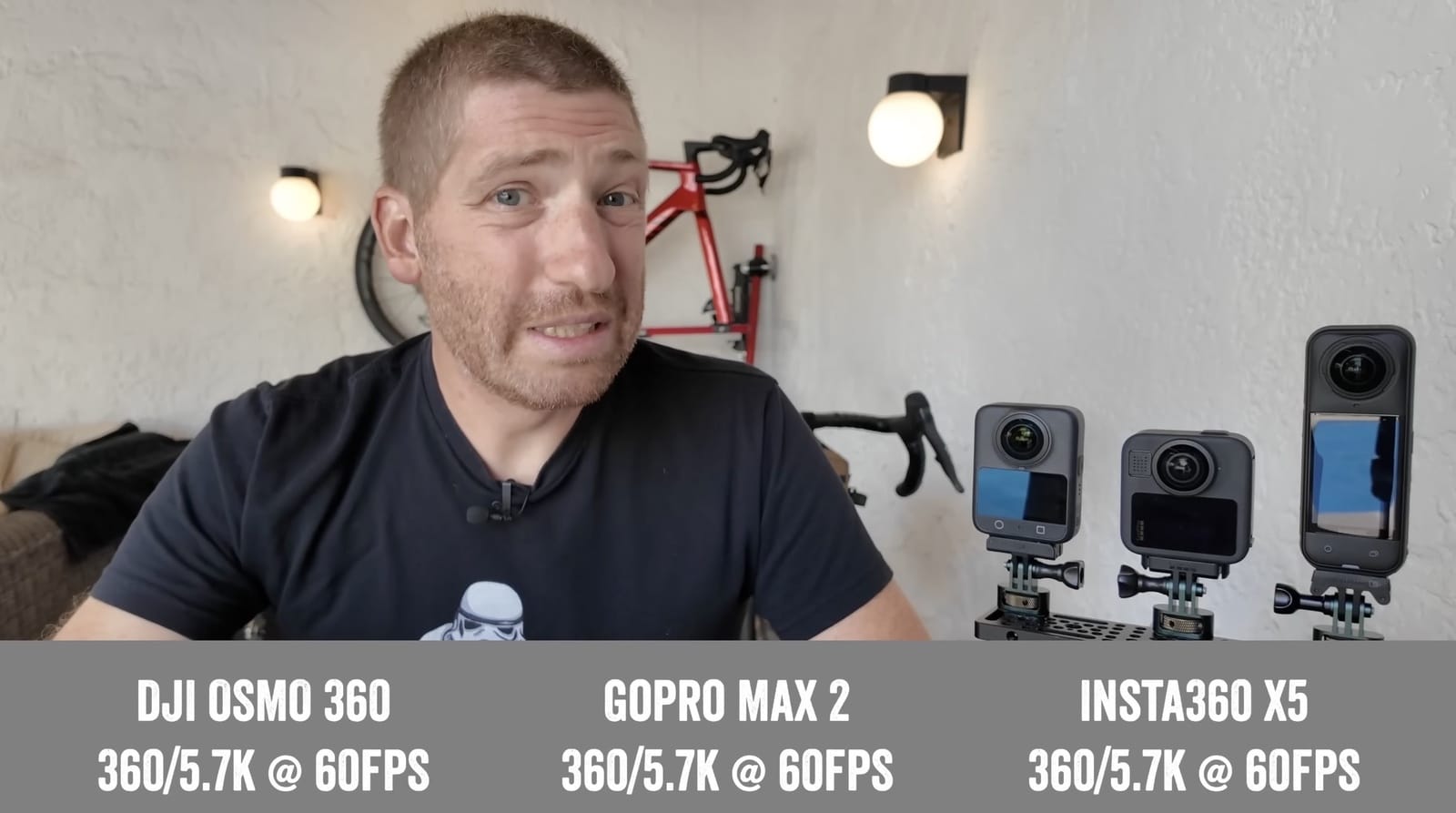 Reviewer beside the Osmo 360, GoPro Max 2 and Insta360 X5 with their 5.7K labels.
