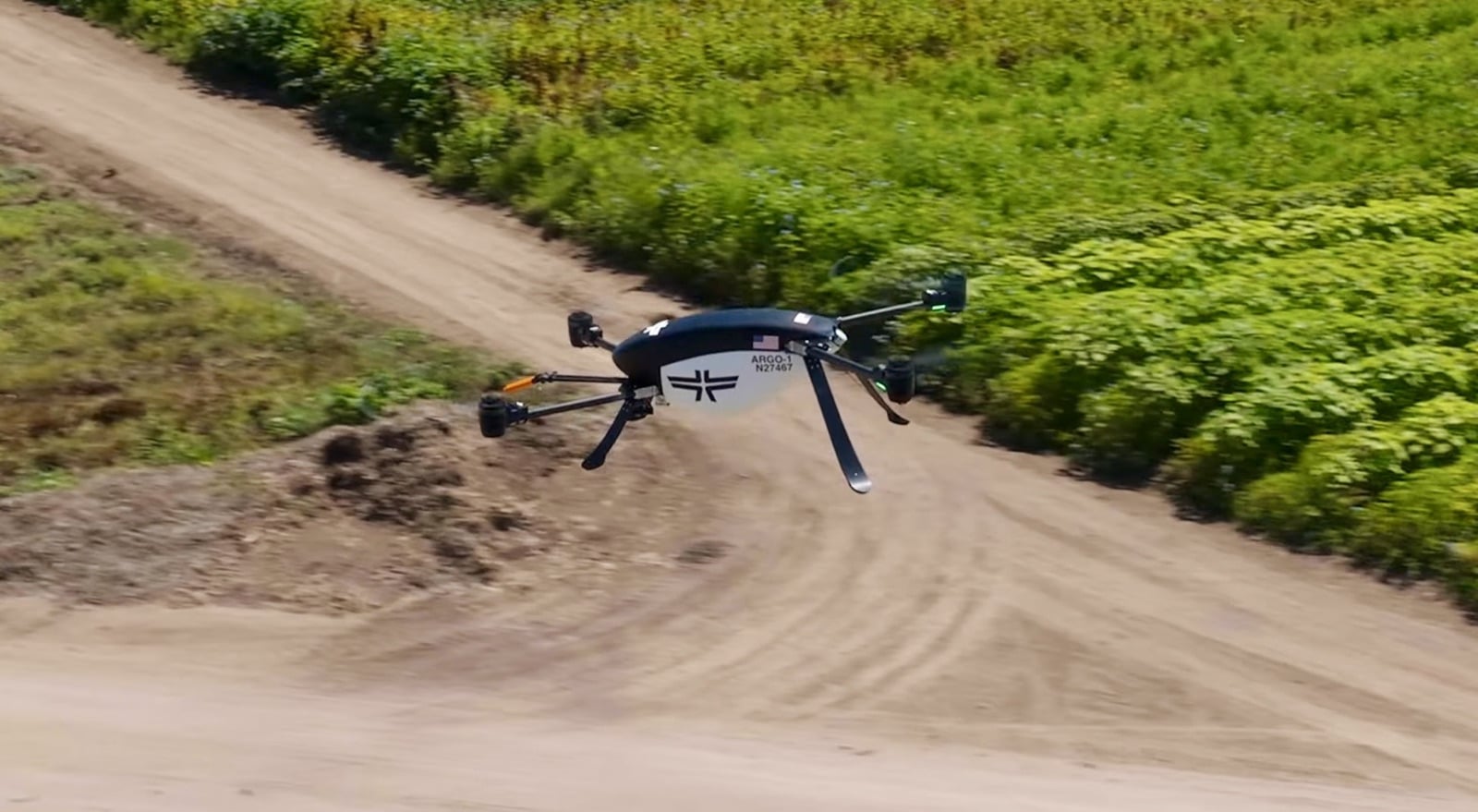 Seneca drones flying as a strike team to lay a foam barrier across open terrain.