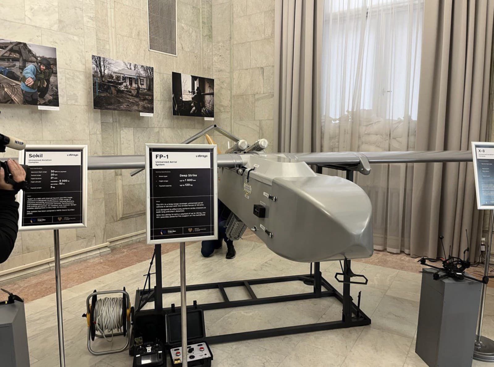 A Fire Point FP-1 strike drone on display beside its specification placard.