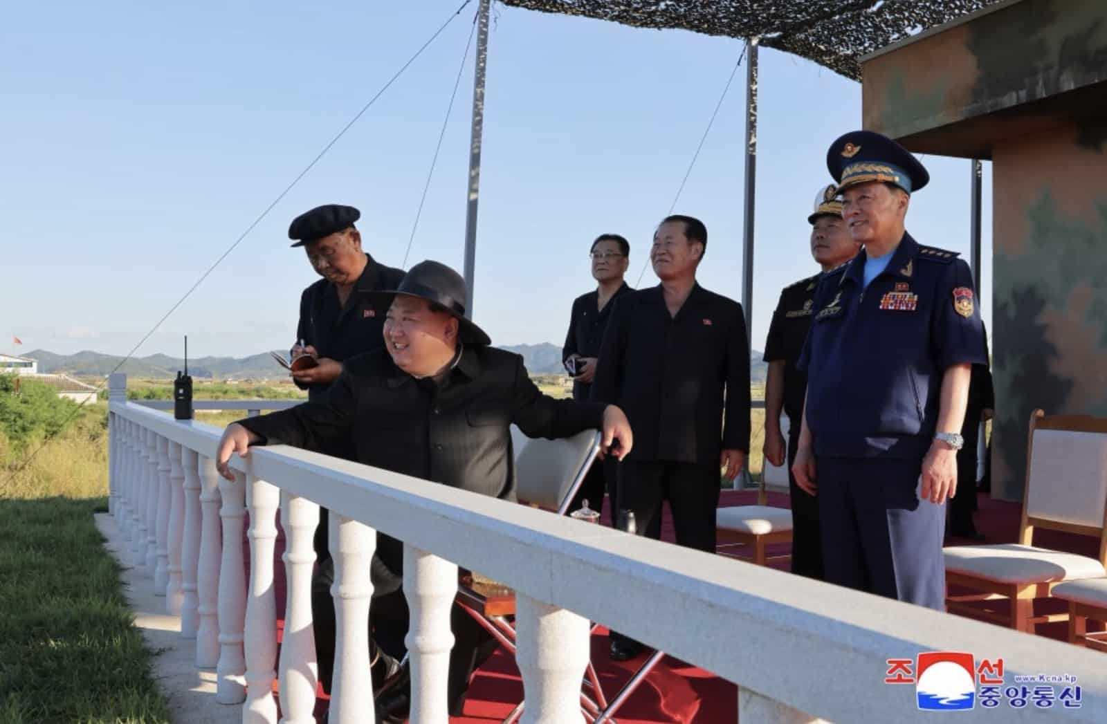 North Korean leadership and air force officers observe the drone test from a platform.