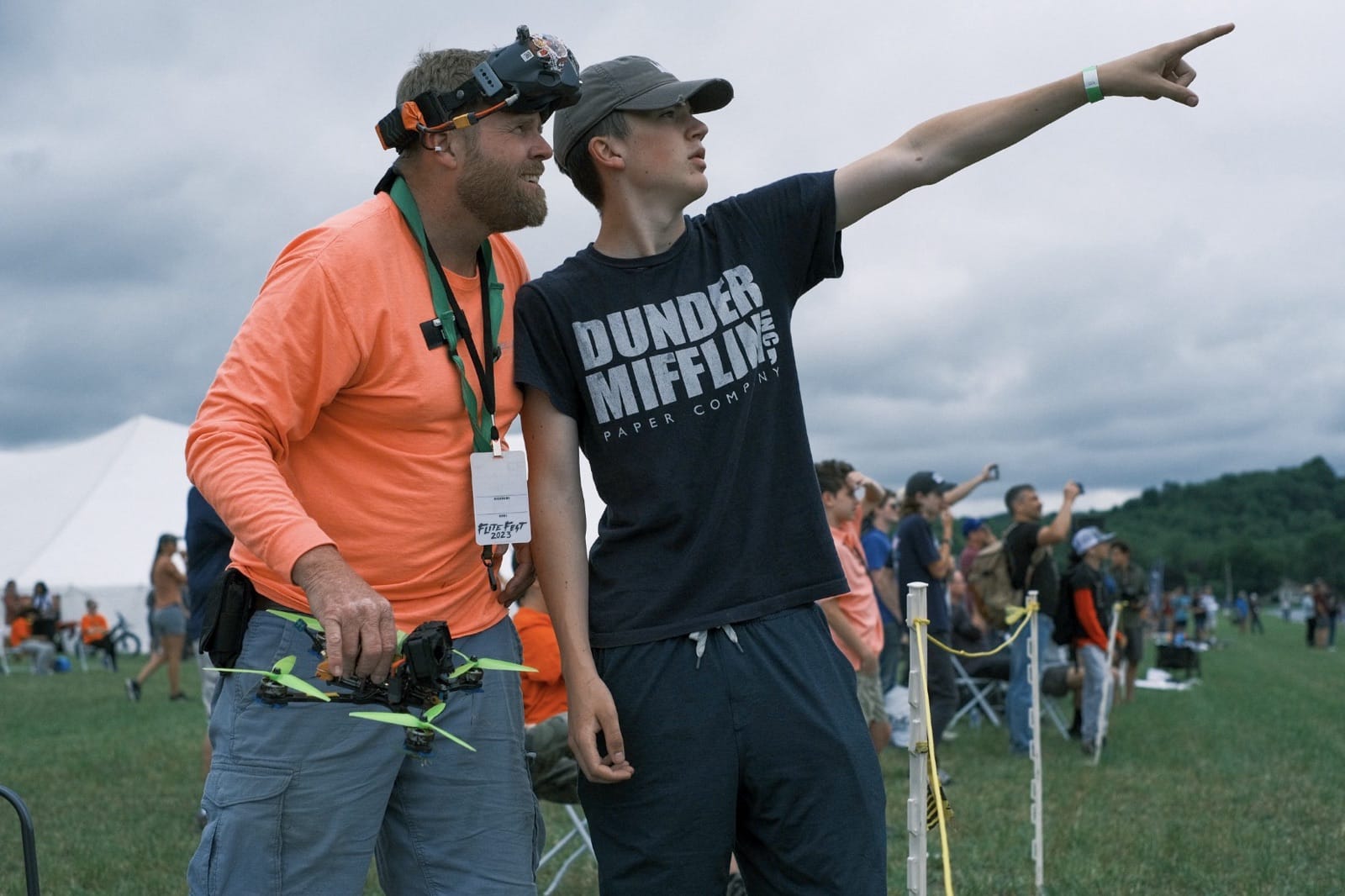 Families gathered under shade canopies at the edge of the Flite Fest 2023 field.