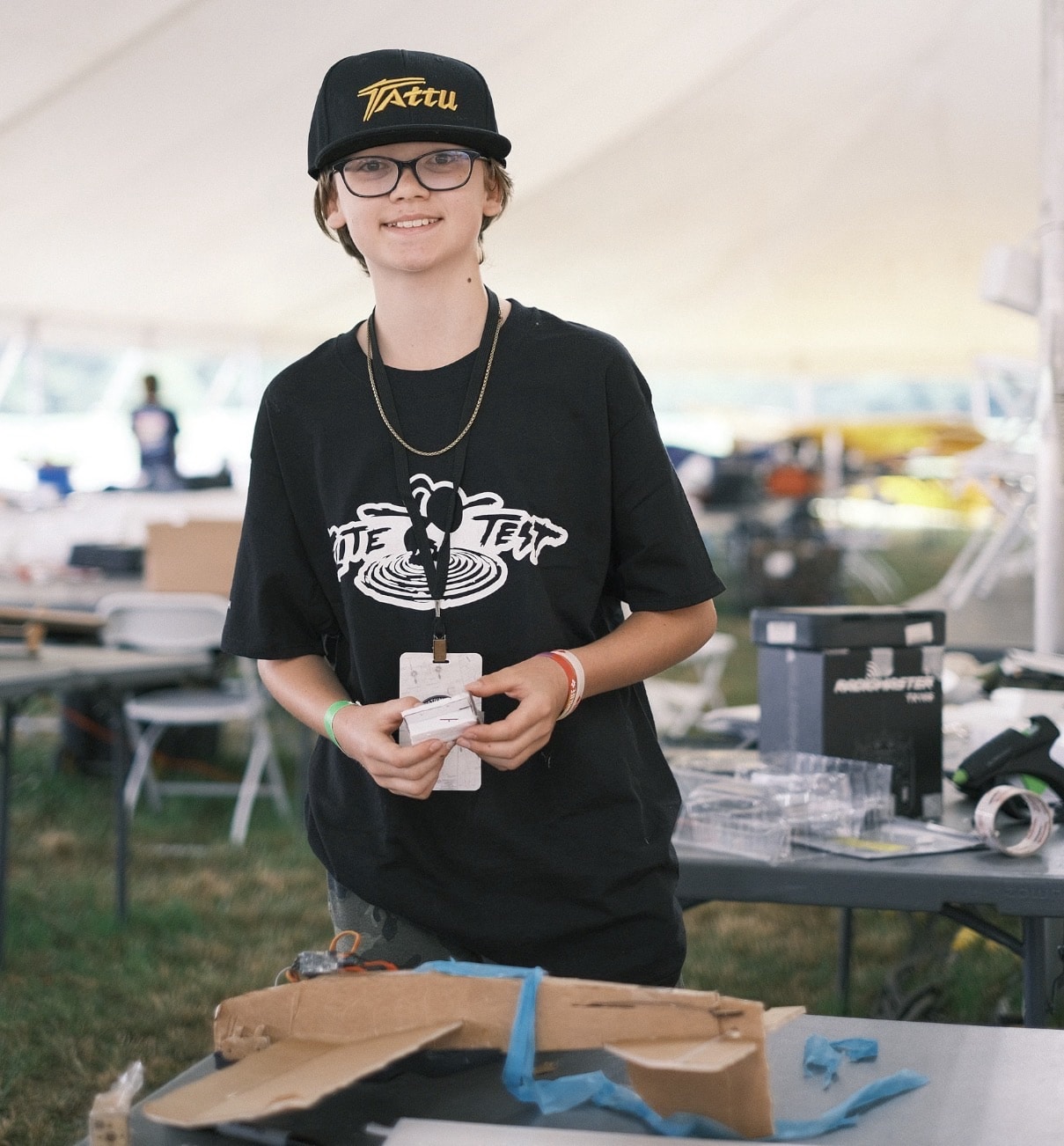 Wide view of the Flite Fest 2023 grounds with tents behind the flying field.