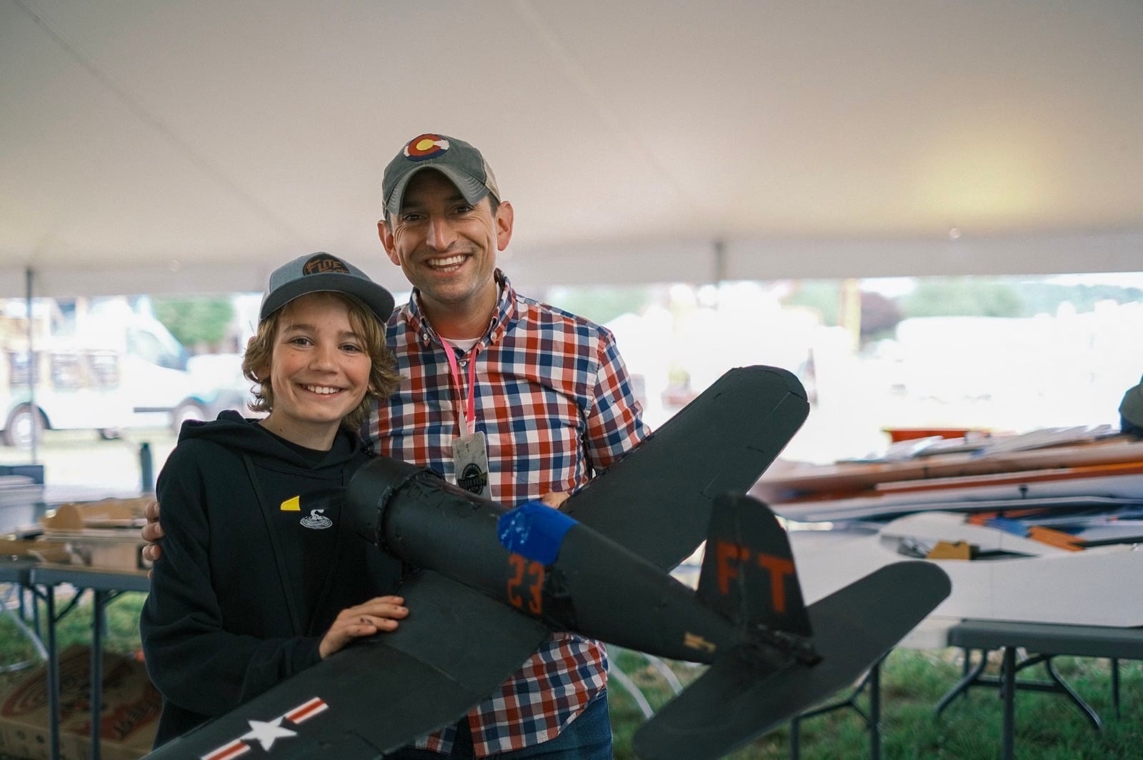 A child at the controls under adult supervision at Flite Fest 2023.