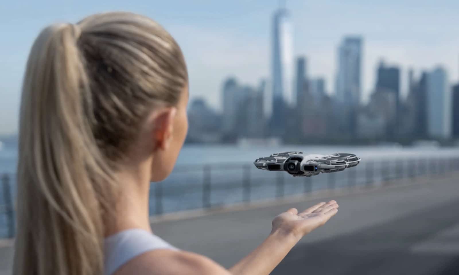 Palm launching the DJI Neo 2 from an open hand on a city street.