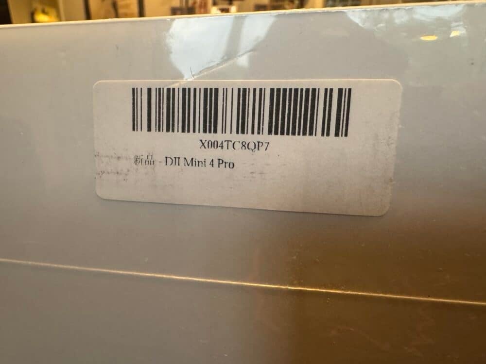 Second parcel label listing the contents as a DJI Mini 4 Pro instead.
