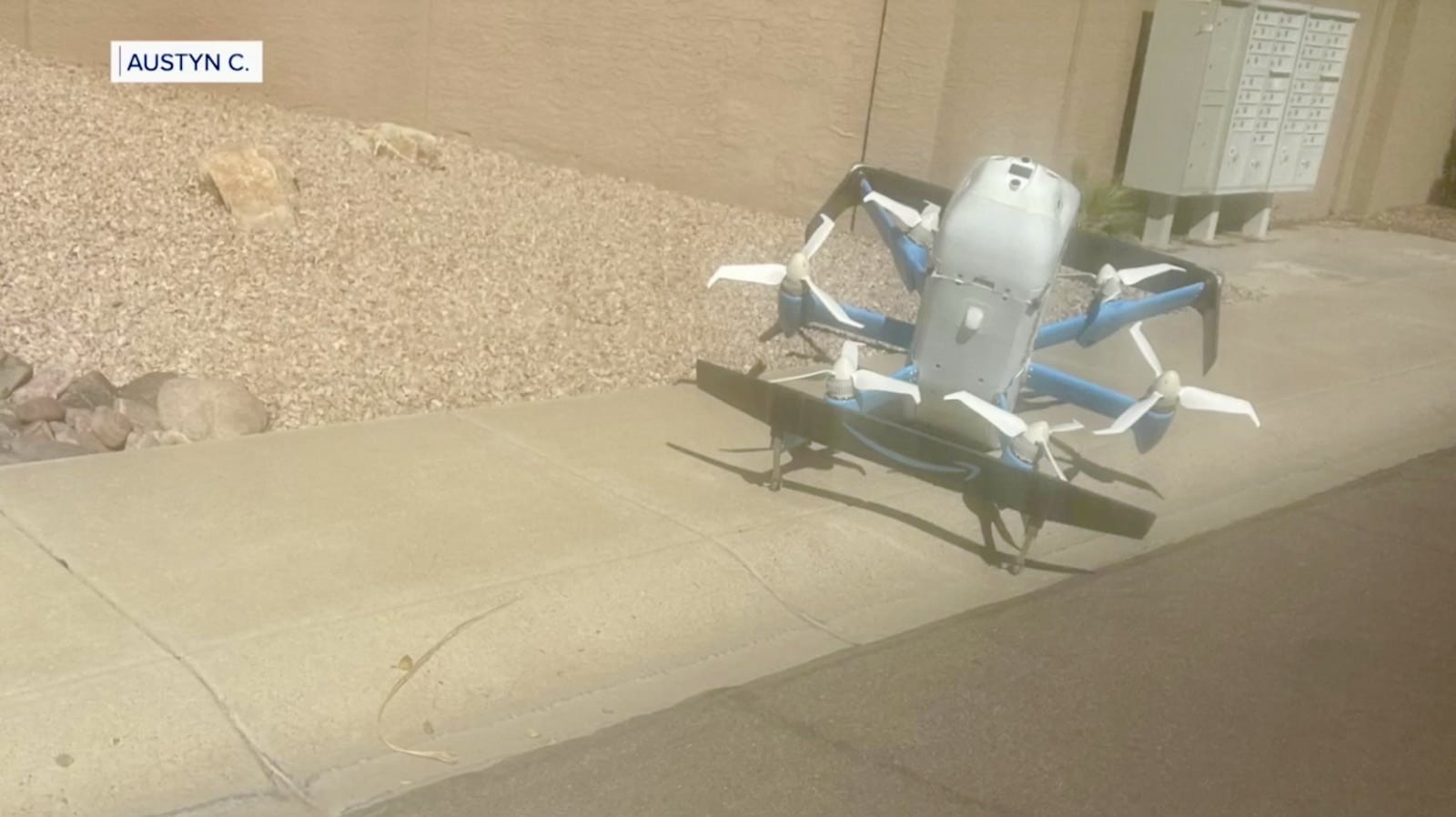 Amazon MK30 delivery drone sitting on a residential sidewalk.