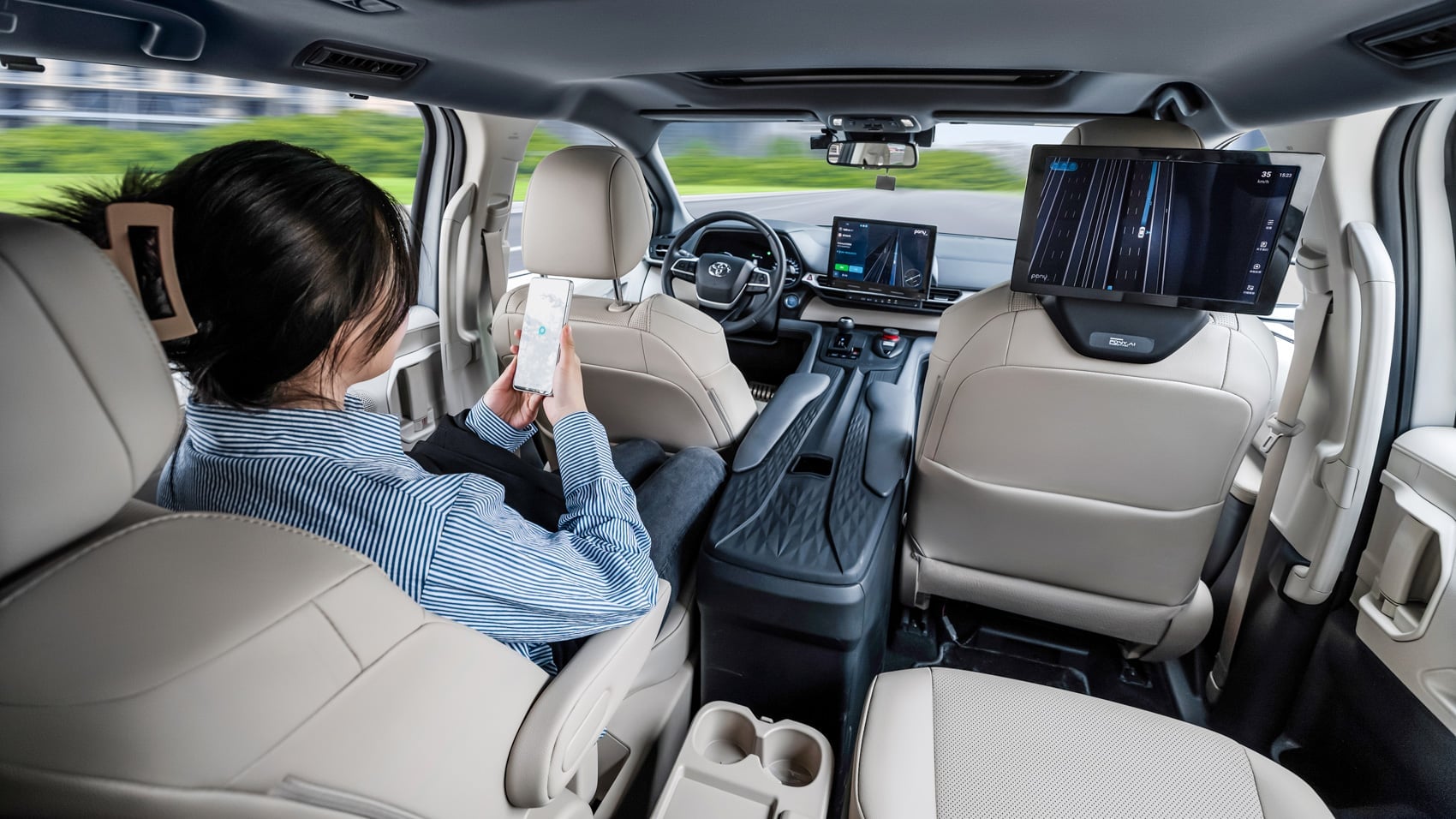 Passenger seated in a Pony.ai robotaxi cabin with no driver at the wheel.