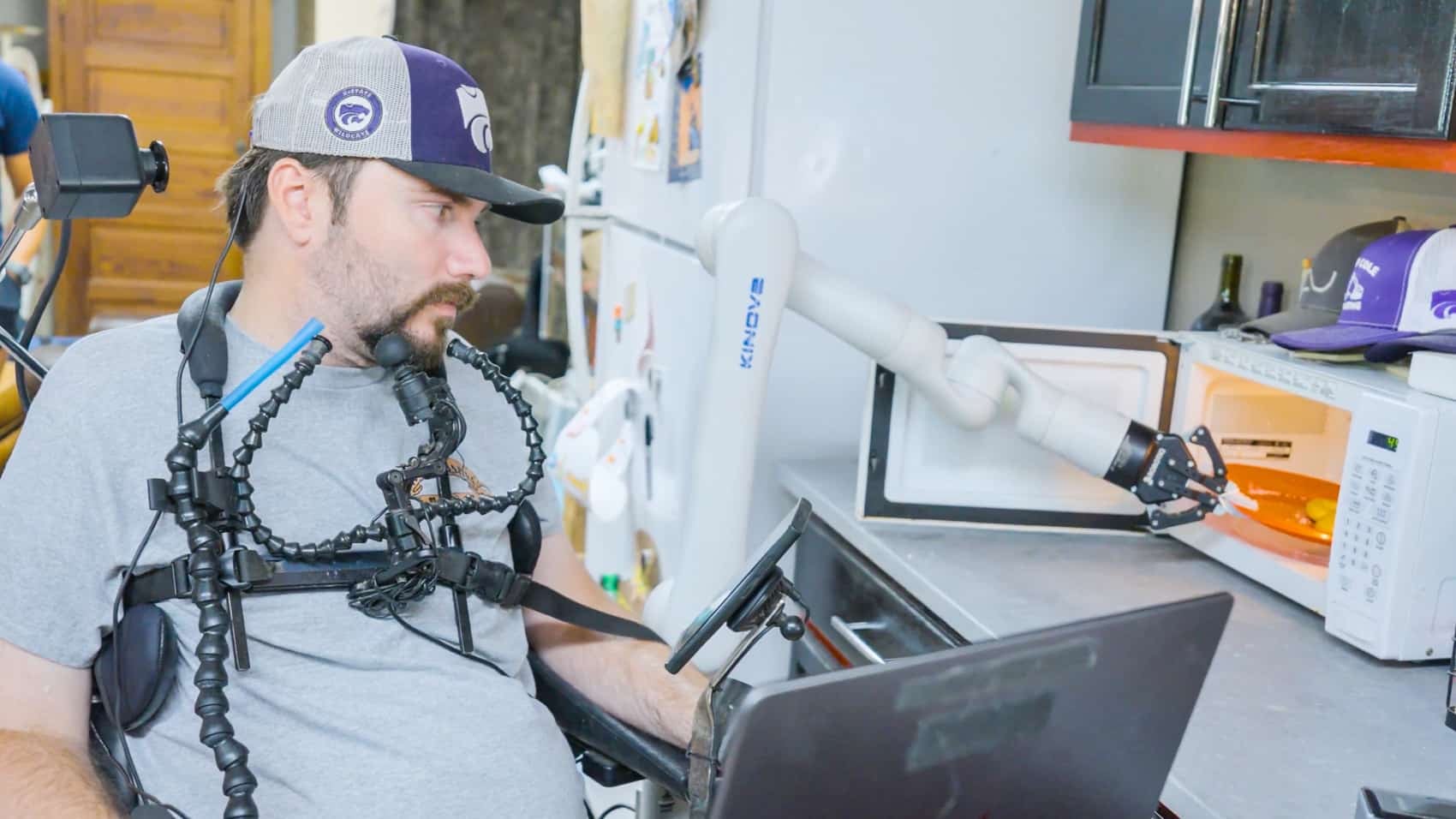 Alex Conley operating a robotic arm through his brain-computer interface.