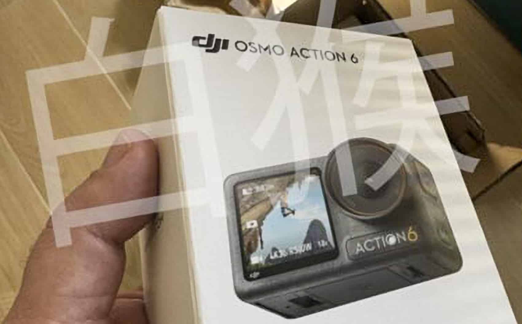 Hand holding a leaked DJI Osmo Action 6 retail box over a cardboard carton.