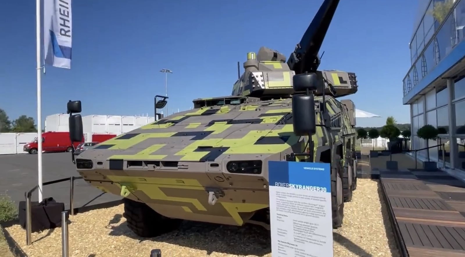 Rheinmetall Skyranger air defence vehicle displayed in camouflage paint at a trade show.