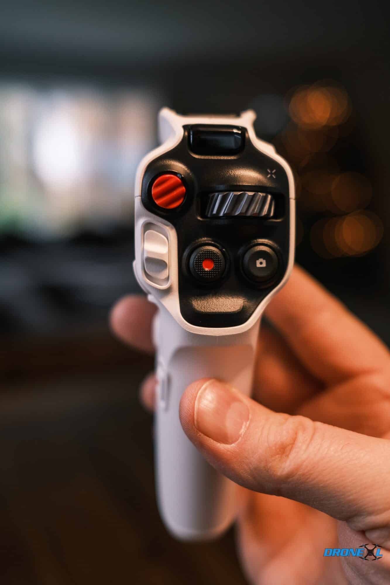 The A1 Grip controller held in one hand for motion-based flying.