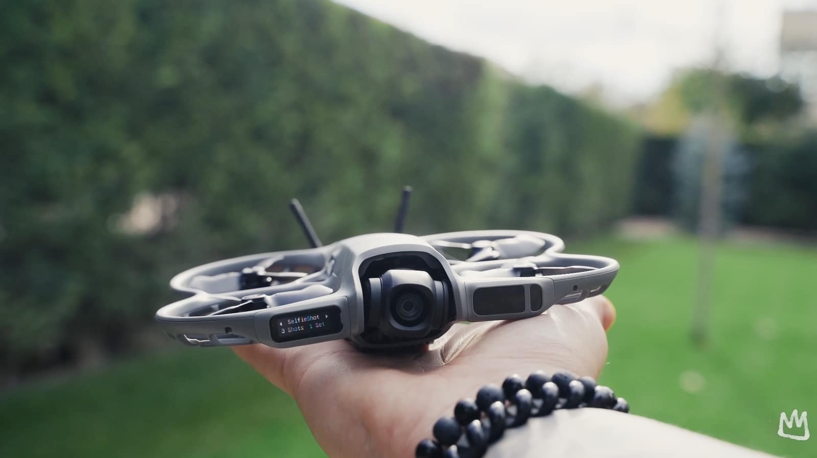 The DJI Neo 2 held in one hand, showing its fully wrapping propeller guards.