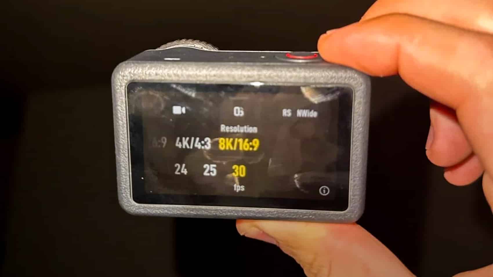 Osmo Action 6 held in hand showing the 8K resolution option highlighted.