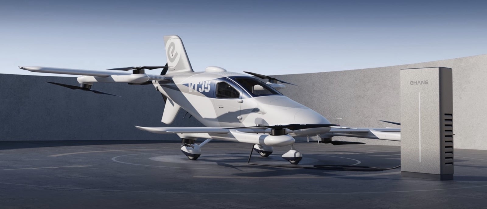 EHang VT35 parked beside a charging cabinet on a landing pad.