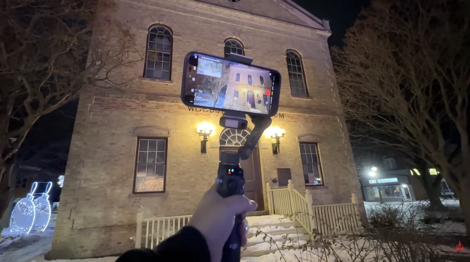Person holding gimbal in snowy night. DJI Osmo Mobile 8 Review: Who Actually Needs a Smartphone Gimbal in 2025?