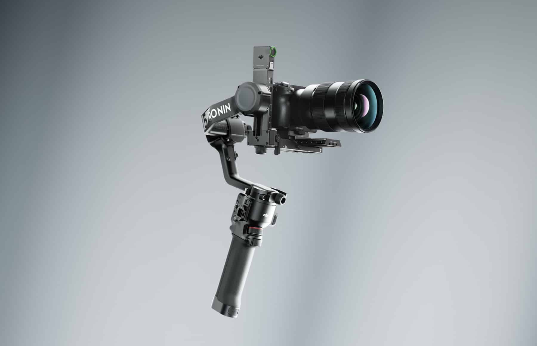 DJI RS 5 gimbal carrying a mirrorless camera against a grey backdrop.