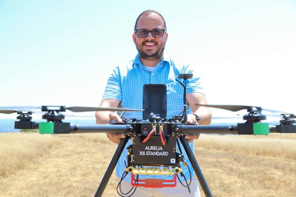 Javier Gonzalez-Rocha, UC Santa Cruz Assistant Professor, holding an air quality monitoring drone
