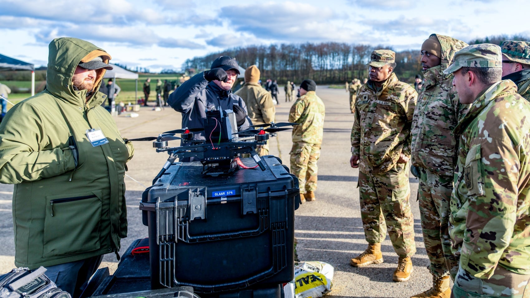 Allied troops gather around counter-drone equipment during the Flytrap 4.5 competition.