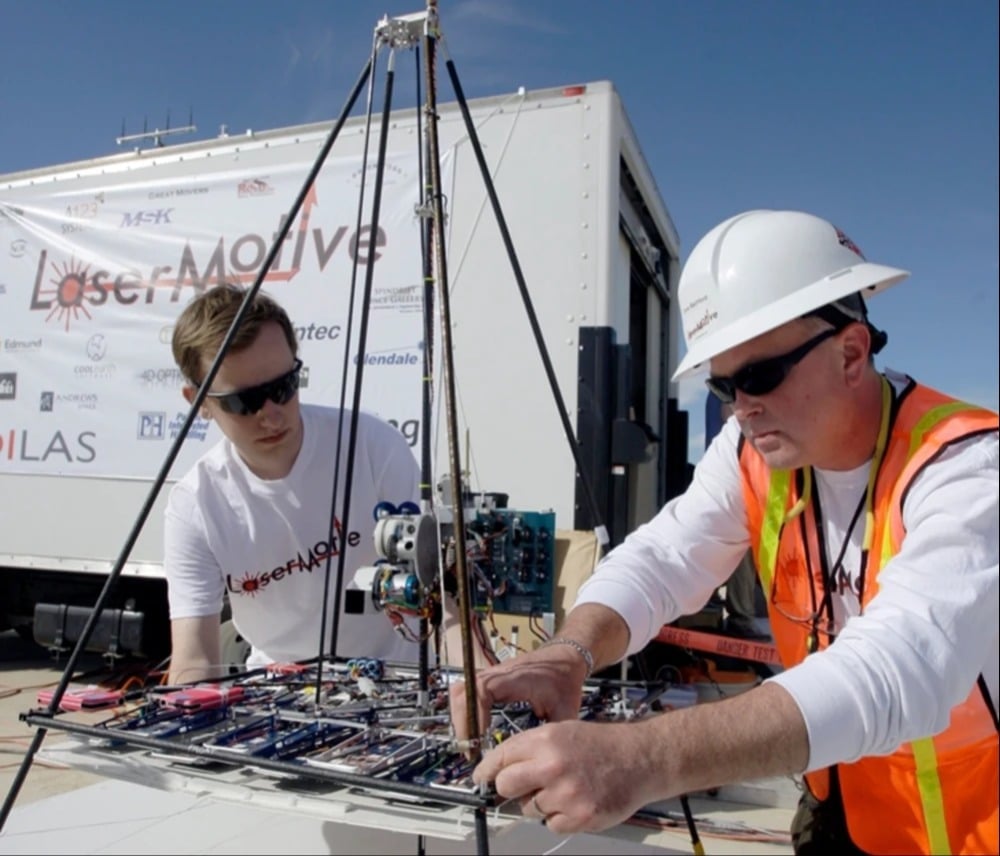LaserMotive's David Bashford, right, prepares a laser-powered drone in 2009 | Photo Credits: Clara Moskowitz
