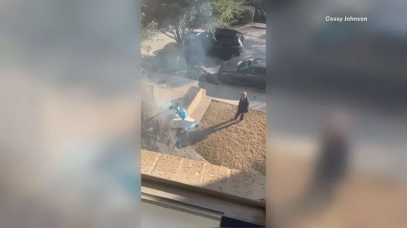 Bystander video of a smoking Amazon delivery drone down on a suburban front lawn.