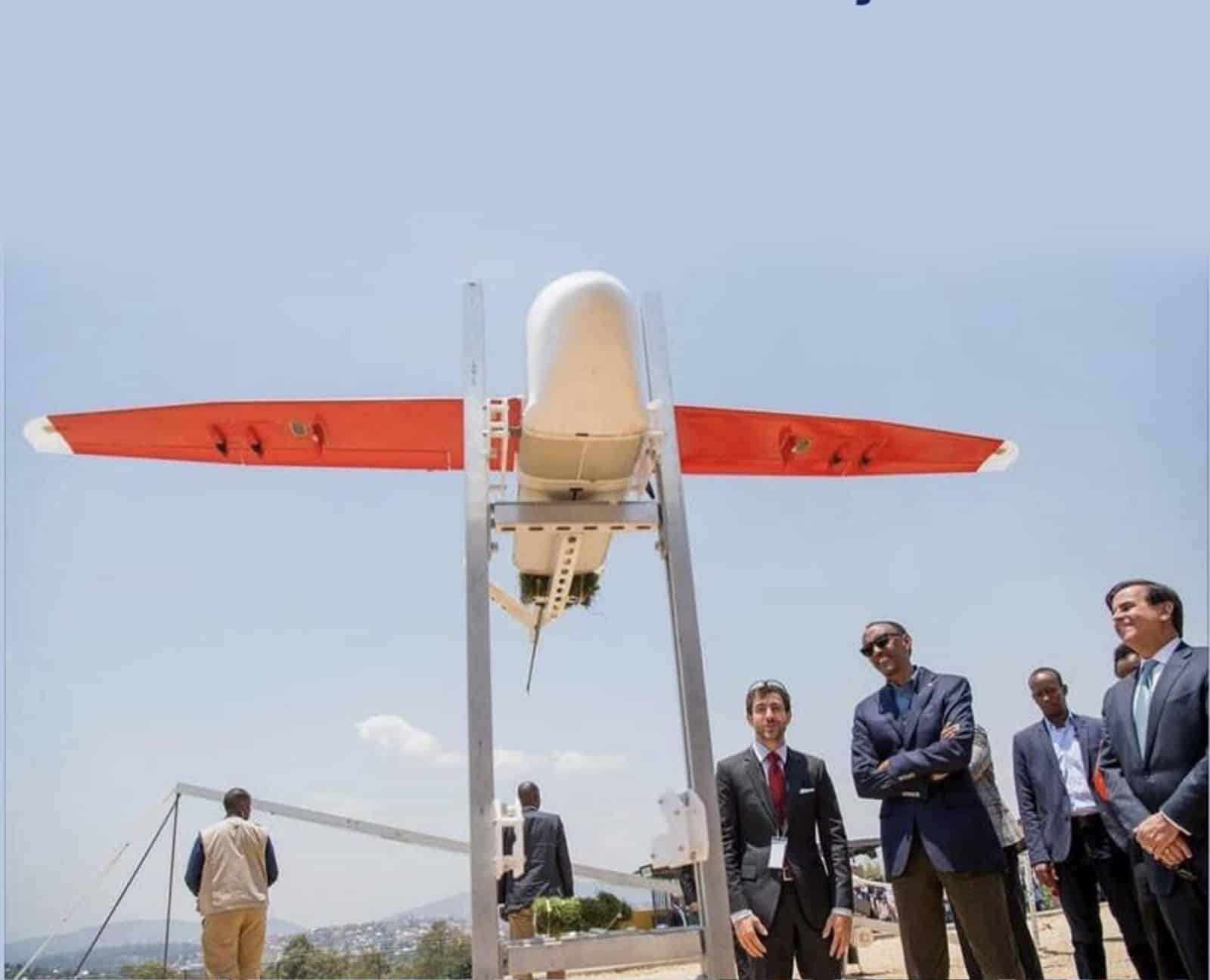 Zipline fixed-wing aircraft poised on its launcher as officials look on.