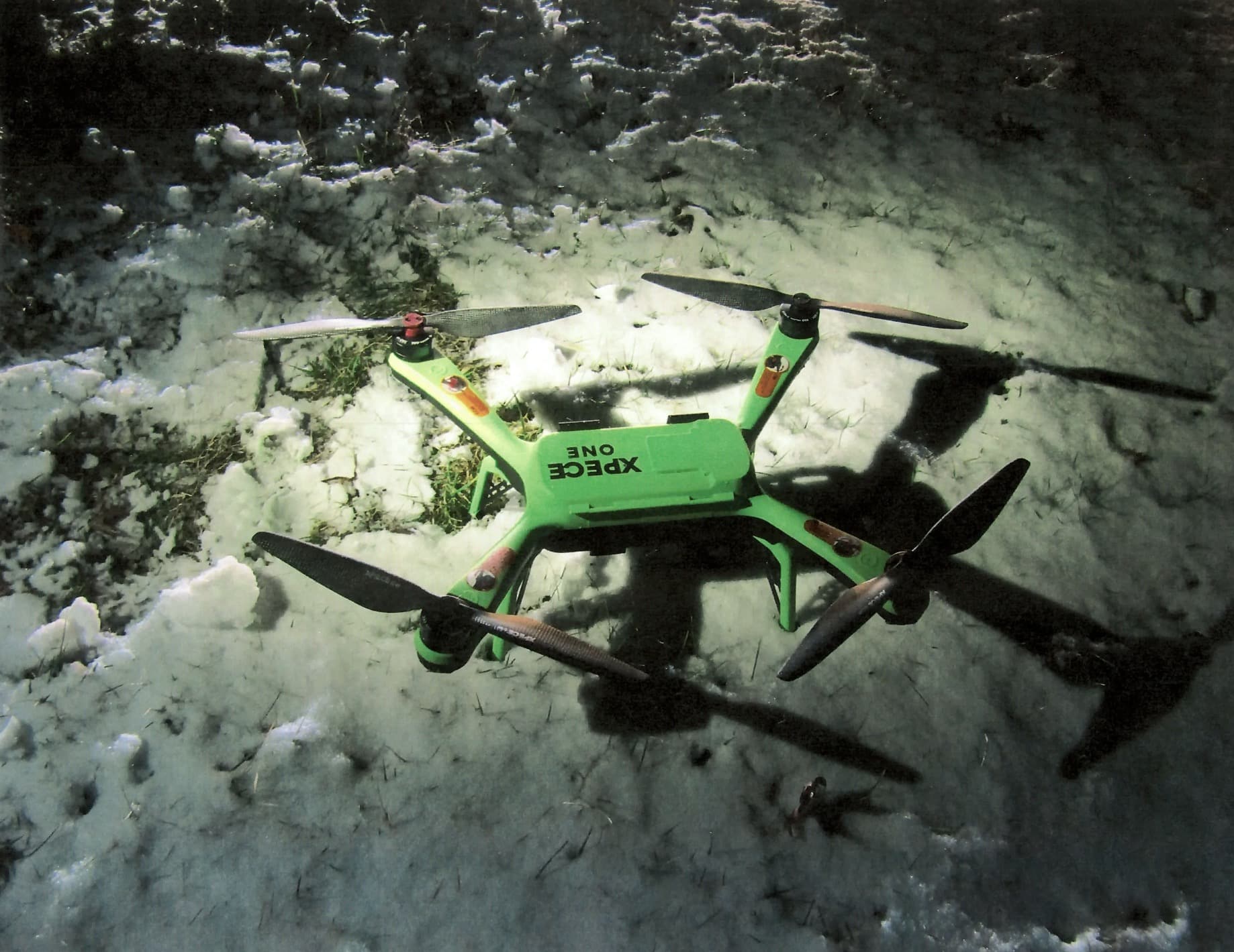The green quadcopter recovered in the snow outside Marcy Correctional Facility.