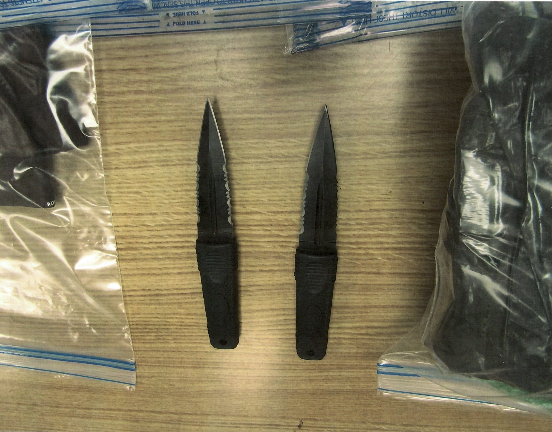 Two eight-inch double-edged knives photographed in evidence bags at Marcy.