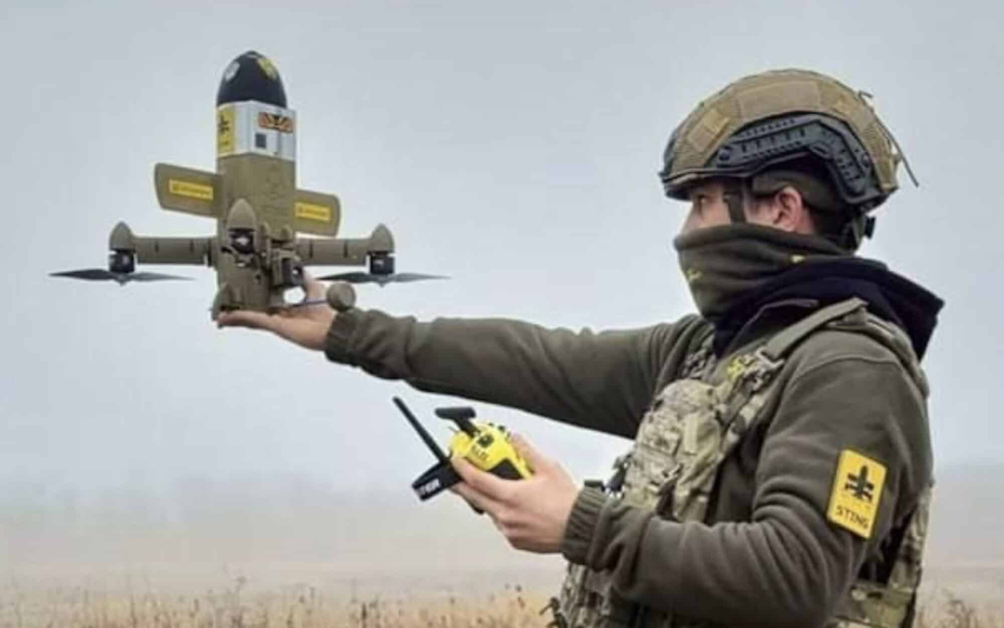 Ukrainian soldier balancing a Sting interceptor drone on his hand before launch.