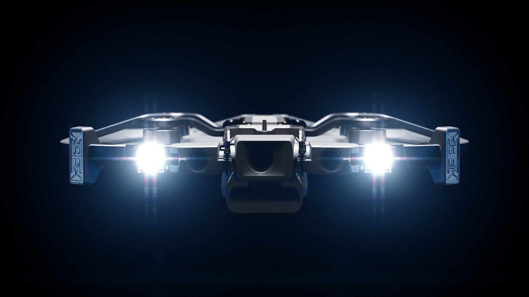 The Skydio R10 indoor drone hovering with twin spotlights on a dark background.