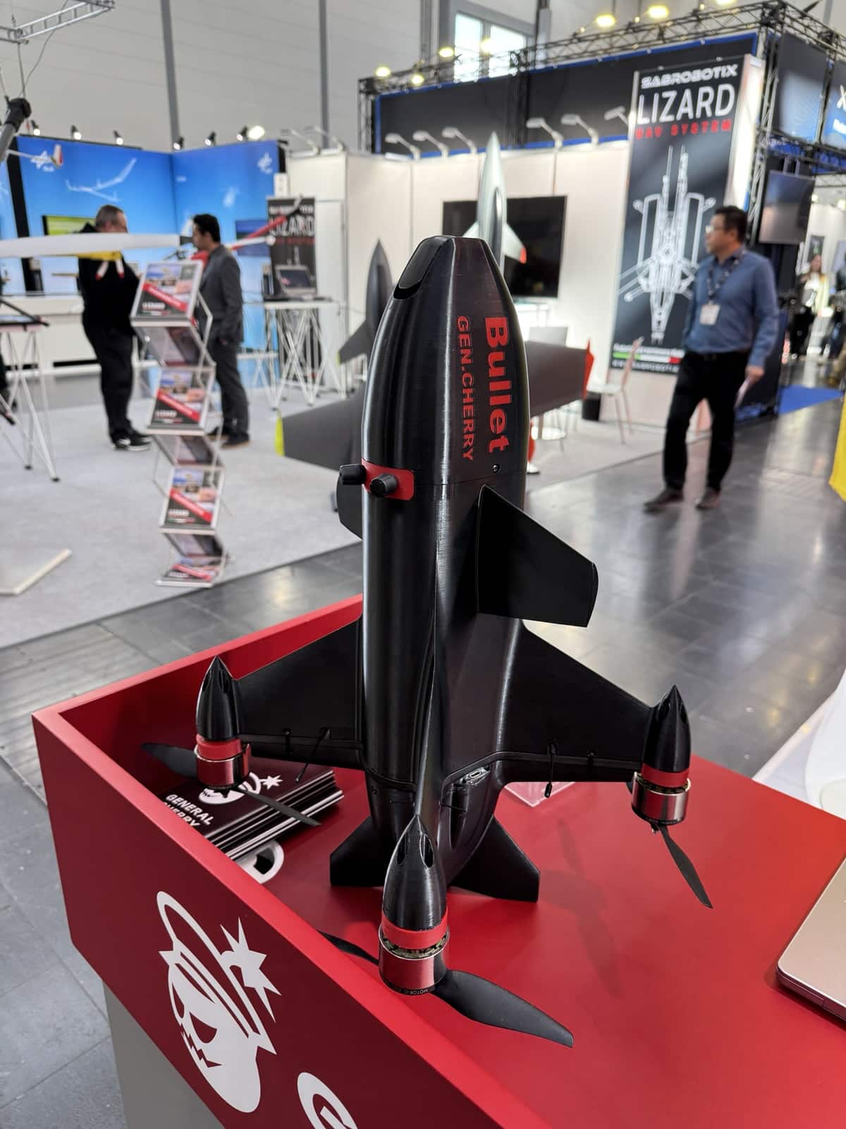 Black Bullet interceptor drone from General Cherry mounted upright on a red exhibition plinth.