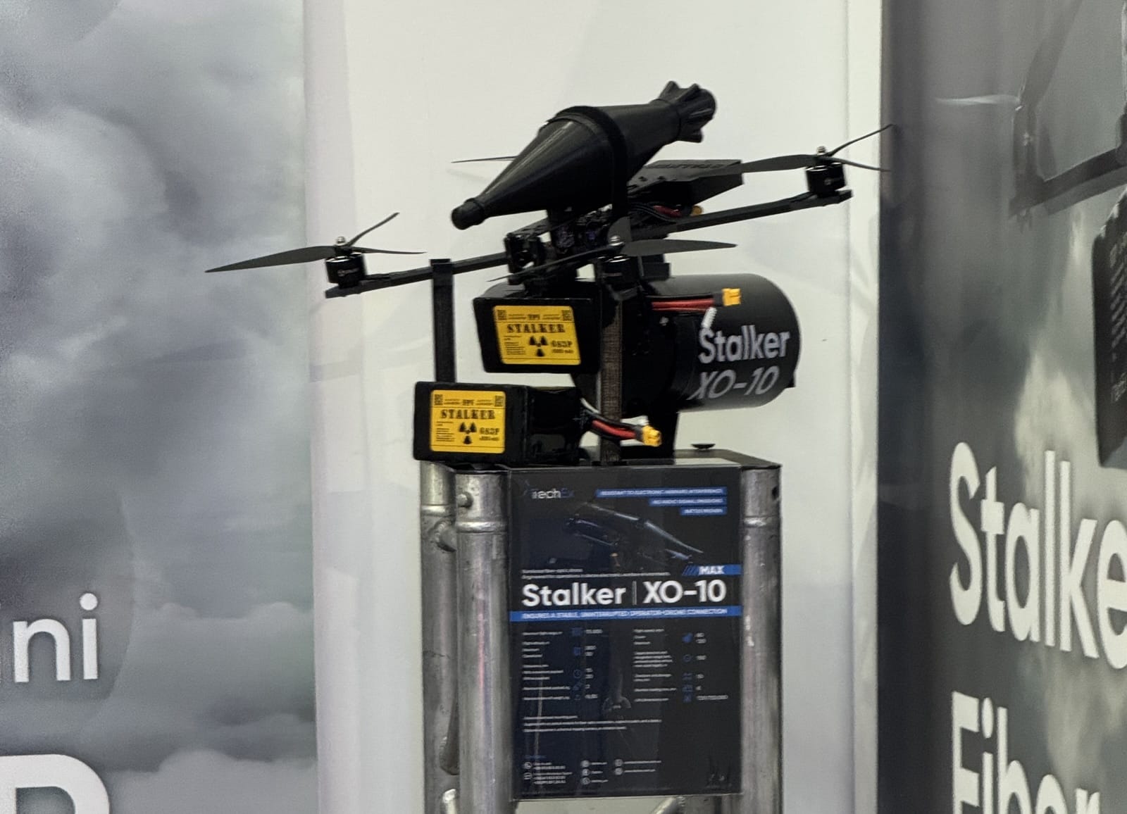 Stalker XO-10 fiber-optic FPV drone with warhead mounted above its spec placard.
