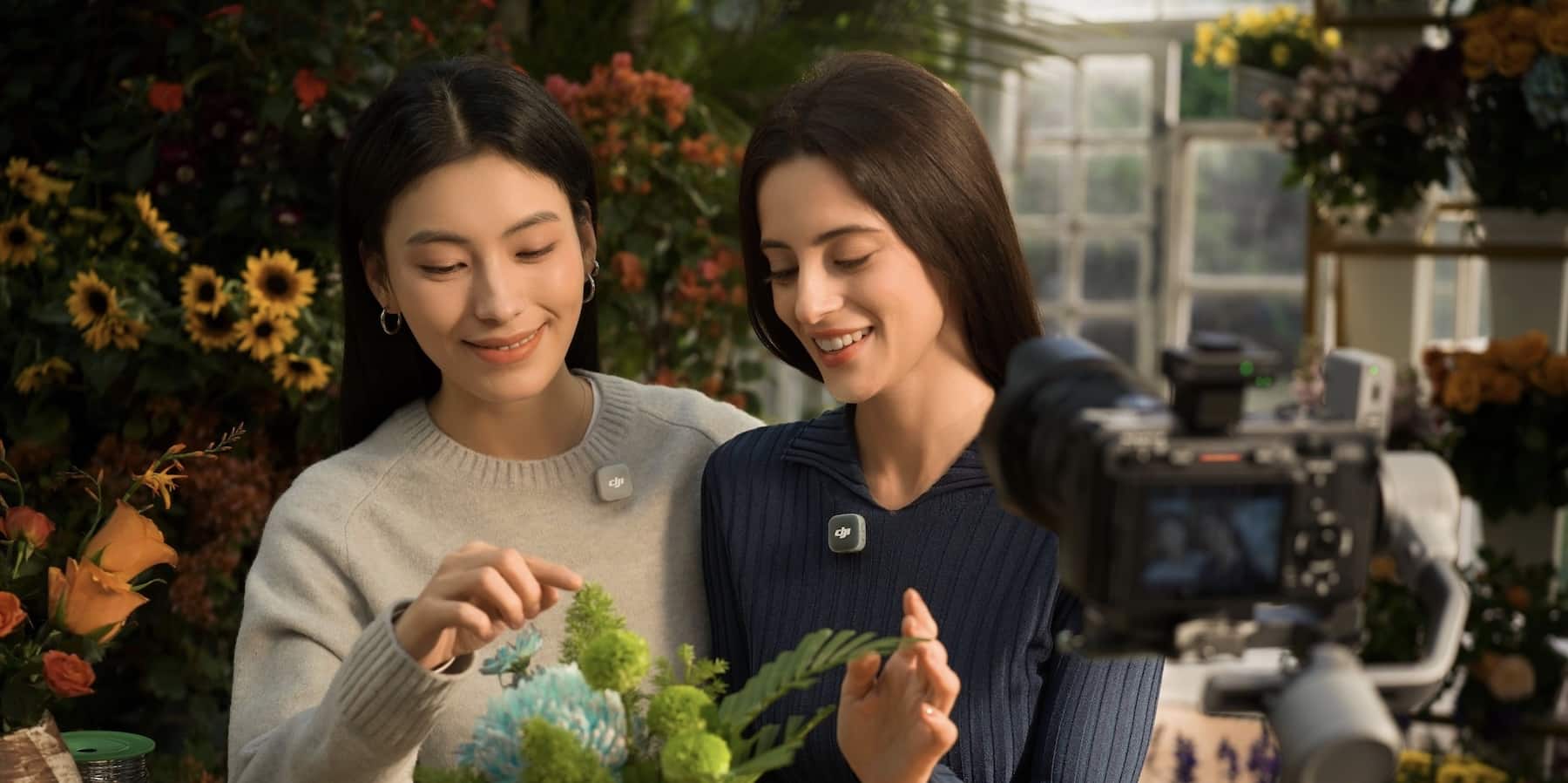 Two women wearing clip-on DJI Mic Mini 2 transmitters filmed in a flower shop.