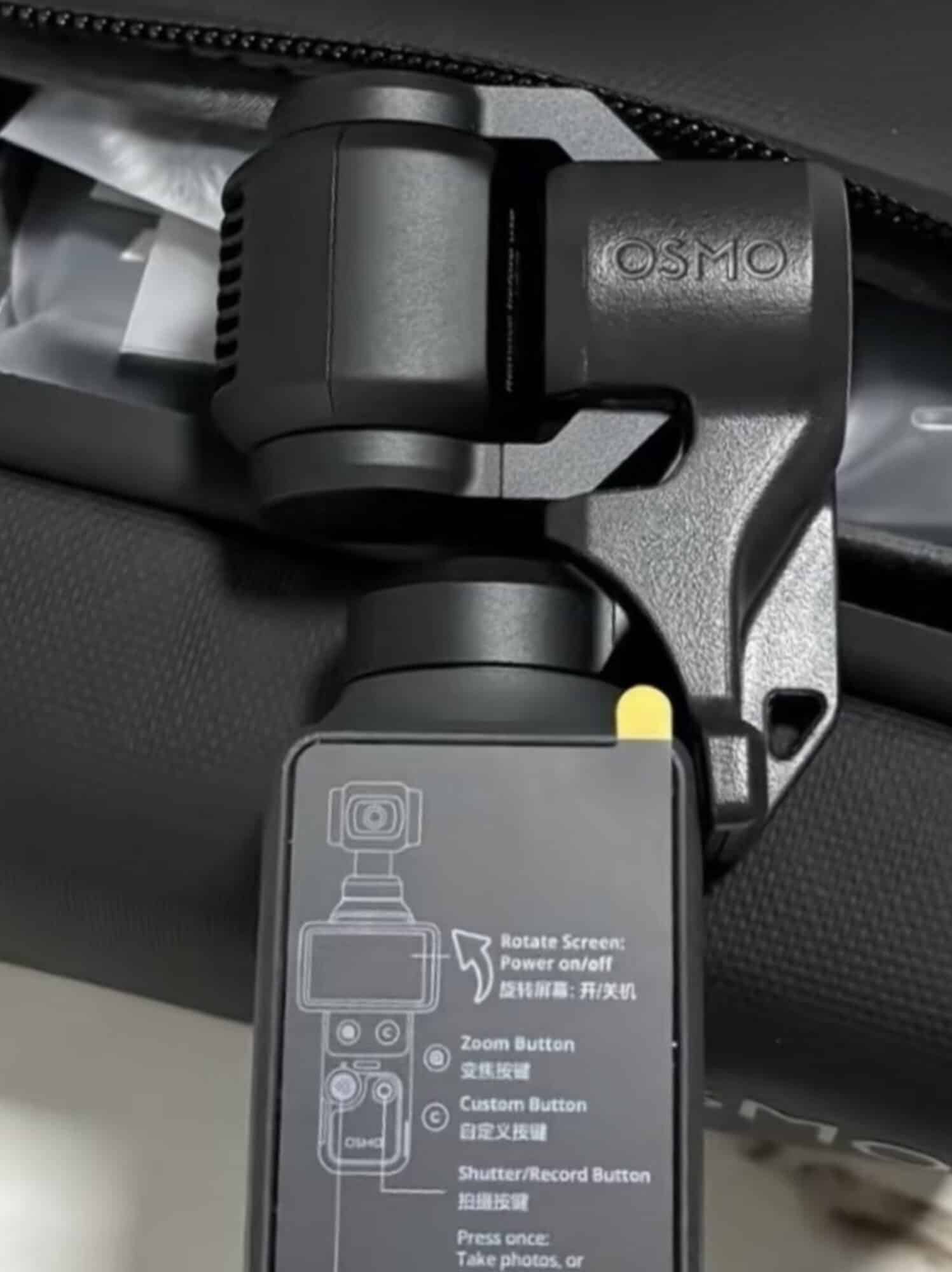 Close-up of the Osmo Pocket 4 gimbal head and its button guide sticker.