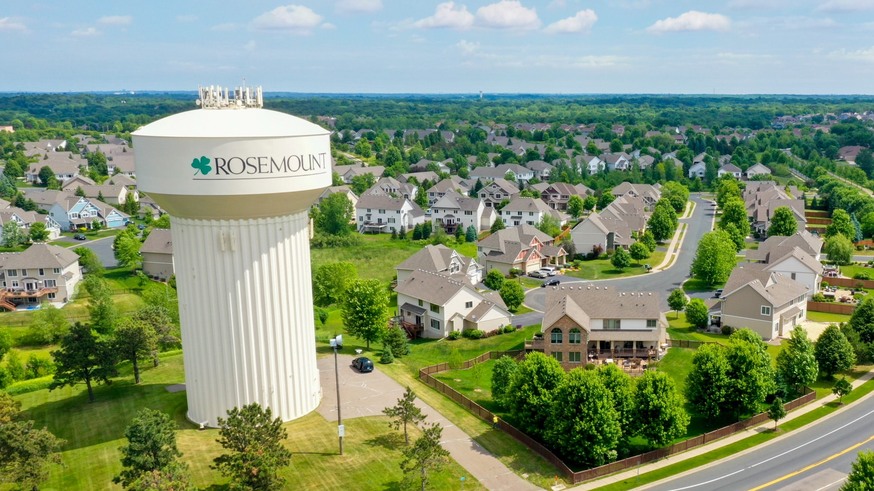 Aerial view of the Rosemount water tower above a green suburban neighborhood.