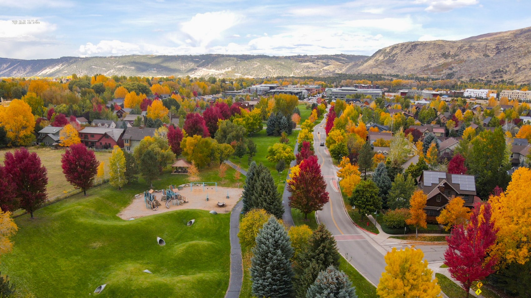 Aerial view of Basalt, Colorado in autumn with a park and surrounding mountains.