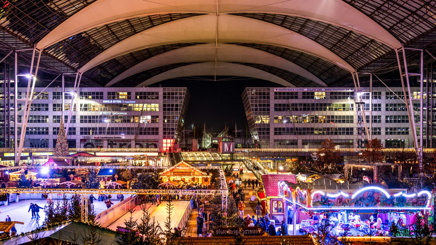 Munich Airport terminal forum at night with its Christmas market and ice rink.