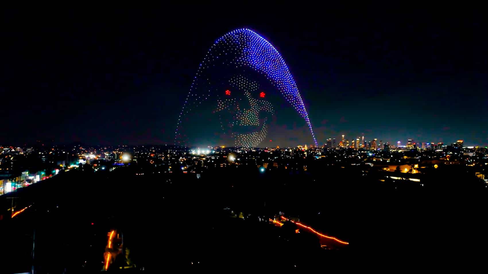 Individual drones holding formation over the Los Angeles skyline at maximum output.