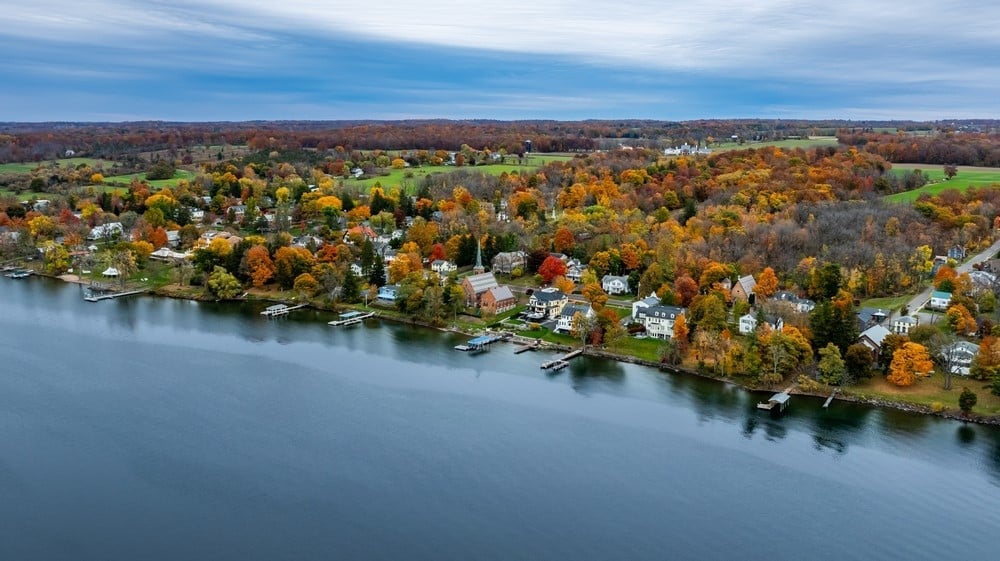 Aerial view of a wooded lakeside neighborhood in upstate New York in autumn.