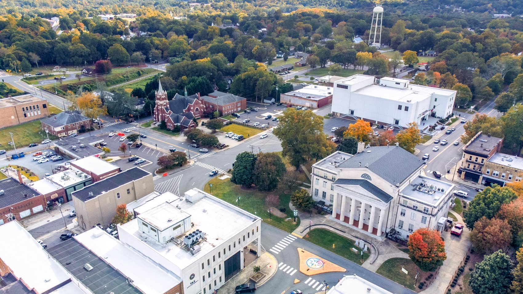 Aerial view of a small North Carolina downtown with courthouse and water tower.