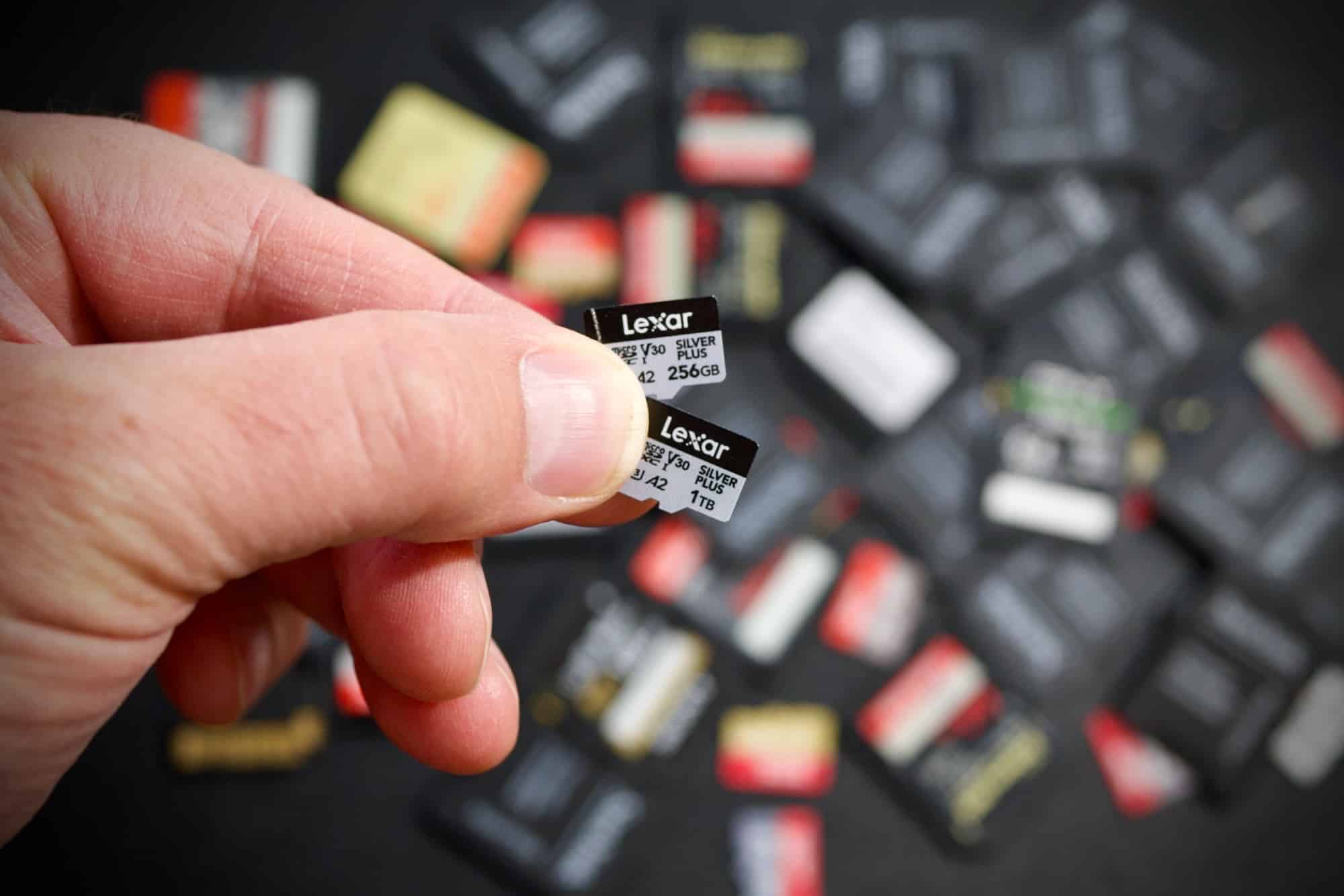 The Lexar Silver Plus 256GB and 1TB microSD cards held between two fingers.