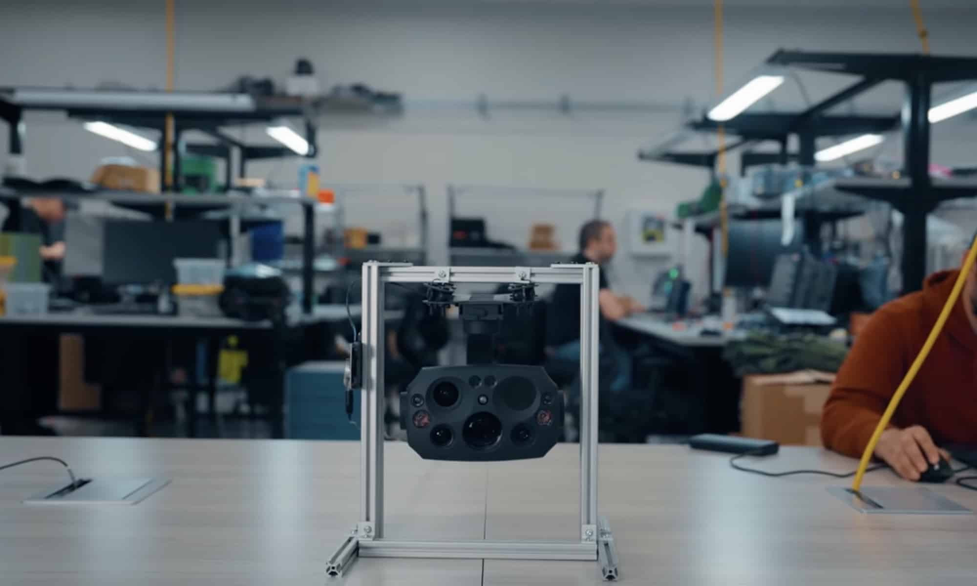 Flock Alpha camera payload mounted on a test rig inside an engineering lab.