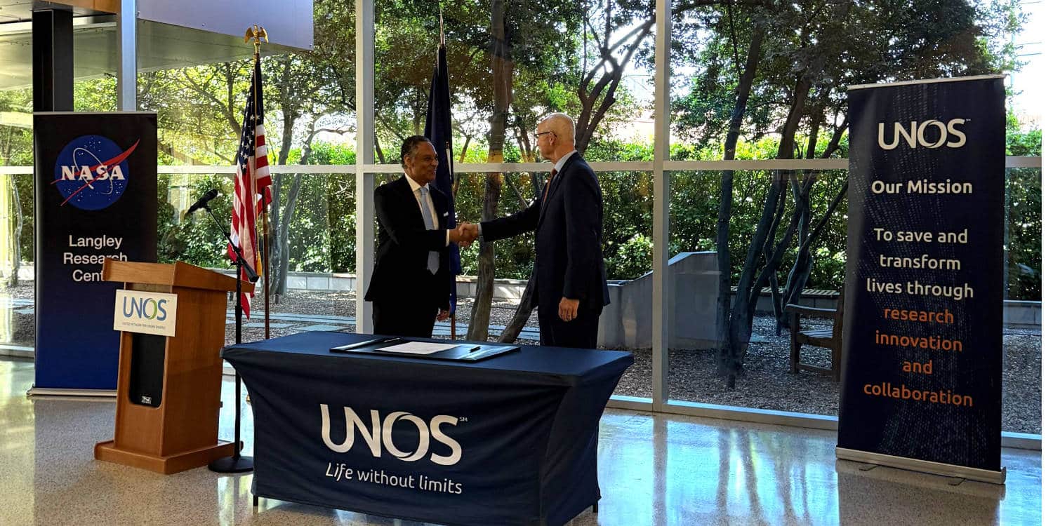 Two officials shaking hands at a NASA Langley and UNOS signing event.